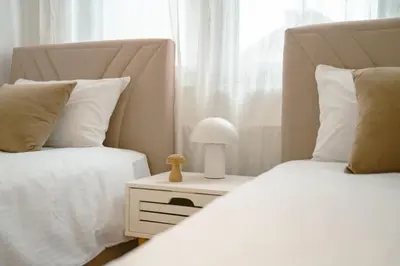 a bedroom with two beds and a lamp on a night stand at Paradise in Bihać
