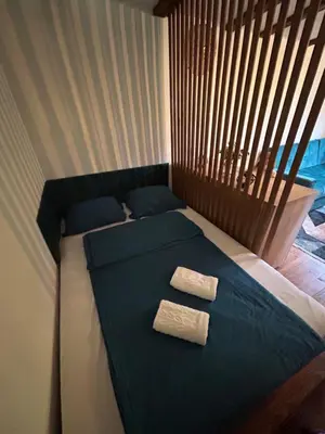 a bed with two towels on it in a bedroom at RELAX HOME Visoko in Visoko