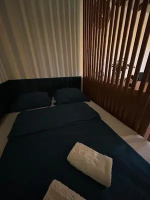 a bed with two towels sitting on top of it at RELAX HOME Visoko in Visoko