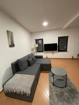 a living room with a couch and a table at Apartman City in Livno