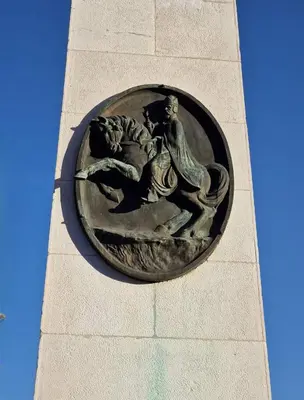 a statue on the side of a clock tower at Apartman City in Livno