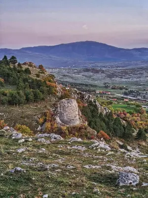a view of a hill with trees and mountains at Apartman City in Livno