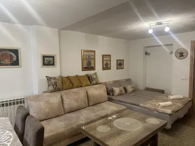 a living room with a couch and a coffee table at Apartment Sky in Visoko