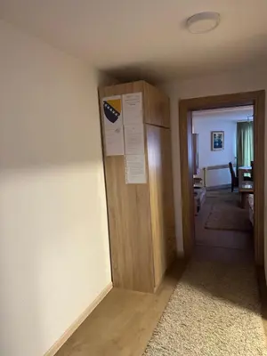 a hallway with a wooden door in a room at Apartment Sky in Visoko