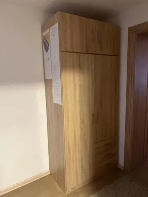 a wooden cabinet in the corner of a room at Apartment Sky in Visoko