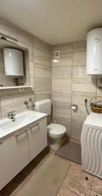 a bathroom with a white sink and a toilet at Apartment Sky in Visoko