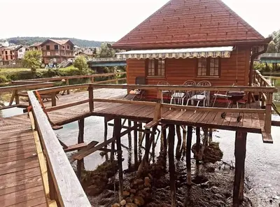 a wooden house on a pier in the water at Natural Paradise in Bosanska Krupa