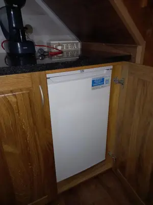 a white dishwasher in a kitchen under a counter at Natural Paradise in Bosanska Krupa