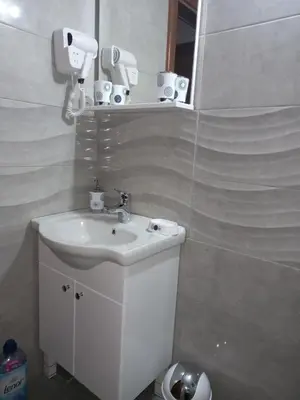 a white bathroom with a sink and a mirror at Natural Paradise in Bosanska Krupa