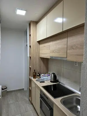 a kitchen with a sink and a stove top oven at Apartman Tamara in Doboj