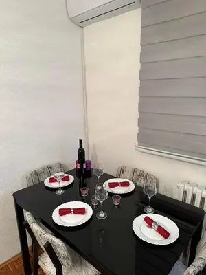 a black table with glasses and a bottle of wine at Apartman Tamara in Doboj