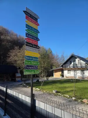 a group of street signs on a pole at Otoka Josikovic in Šipovo