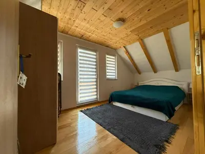 a bedroom with a bed and a wooden ceiling at Otoka Josikovic in Šipovo