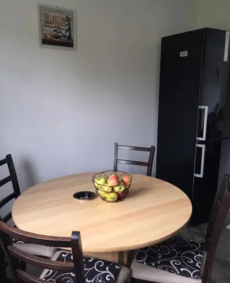 a wooden table with a bowl of fruit on it at Vikendica Fenix in Banja Luka