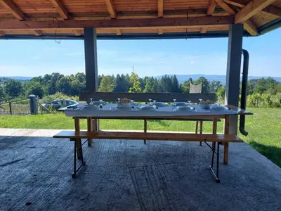 a table with dishes on top of it on a patio at Vikendica Fenix in Banja Luka
