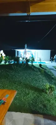 a view of a garden with a person in the background at Vikendica Fenix in Banja Luka