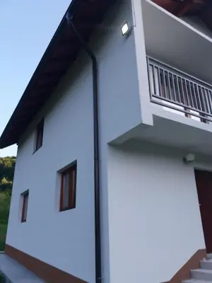a white building with windows and a balcony at Villa Goleš Travnik in Travnik
