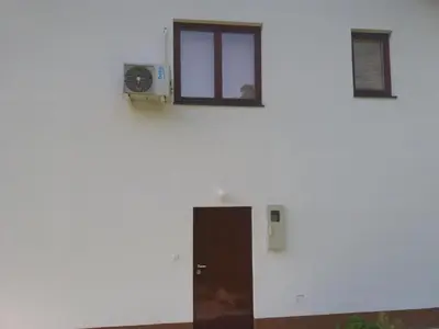 a white wall with a door and a window at Villa Goleš Travnik in Travnik