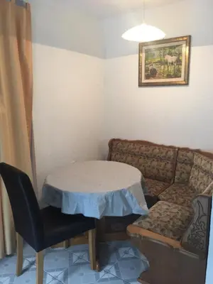 a living room with a table and a couch at Apartman SUNCE in Jajce