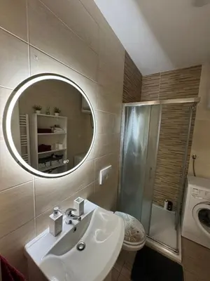 a bathroom with a sink and a mirror at Apartman Ana in Doboj
