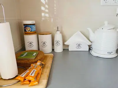 a kitchen counter with dishes and utensils on it at Apartman Ana in Doboj