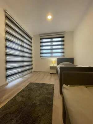 a living room with two beds and a couch at Ammirevole Ravne Apartments in Visoko