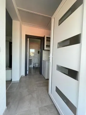 a hallway with a door to a bathroom with a toilet at Ammirevole Ravne Apartments in Visoko
