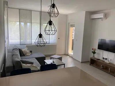 a living room with a couch and a tv at Slijepcevic in Teslić