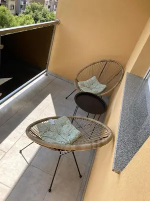 a balcony with two chairs and a table at Slijepcevic in Teslić