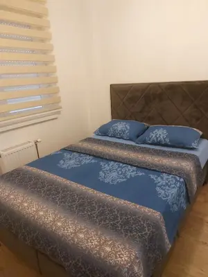 two beds with blue pillows in a bedroom at Apartman Vrbas sa Podzemnom garazom in Banja Luka