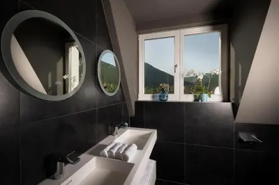 a bathroom with a sink and a mirror at Resort Una Park in Bihać