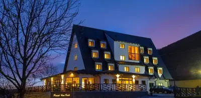 a large building with lights on in the night at Resort Una Park in Bihać