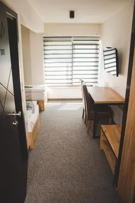 a room with a table and chairs and a window at Motel Bihać in Bihać