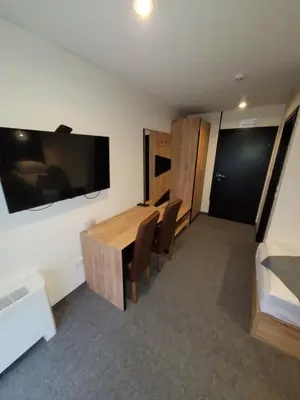 a conference room with a table and chairs and a tv at Motel Bihać in Bihać