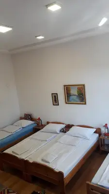 two twin beds in a room with a wall at Apartment and rooms