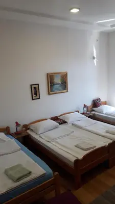 a group of three beds in a room at Apartment and rooms