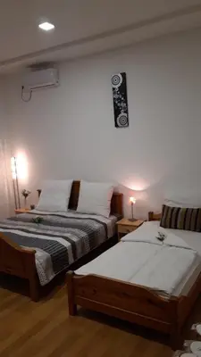 a bedroom with two beds and a sign on the wall at Apartment and rooms