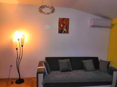 a living room with a couch and a lamp at Milgor in Banja Luka