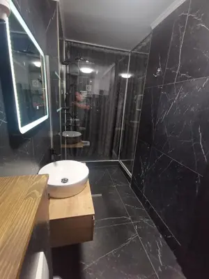 a bathroom with a white sink and a shower at City-centar in Banja Luka