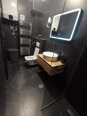 a bathroom with a sink and a toilet and a mirror at City-centar in Banja Luka
