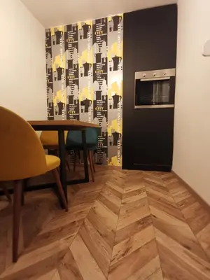 a dining room with a table and a microwave at City-centar in Banja Luka