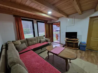 a living room with a couch and a table at Vikendice Bungalovi Menzil in Zavidovići