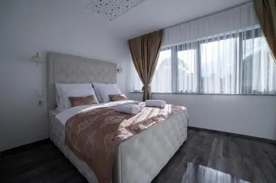 a bedroom with a large bed with two pillows on it at Royal Residence Deluxe Apartments in Bihać