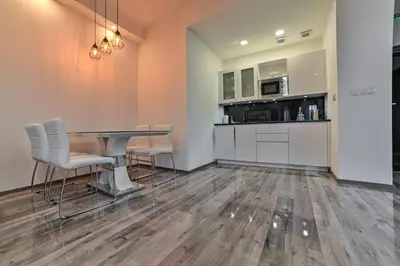 a kitchen and dining room with a table and chairs at Royal Residence Deluxe Apartments in Bihać