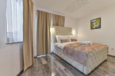 a bedroom with a large bed in a room at Royal Residence Deluxe Apartments in Bihać