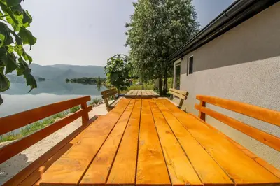 a wooden deck with a view of a lake at ''Lake House Jana'' Ramsko Jezero in Prozor