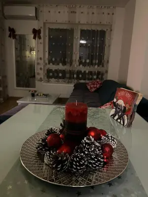 a cake on a glass plate on a table at Apartment M & N in Banja Luka