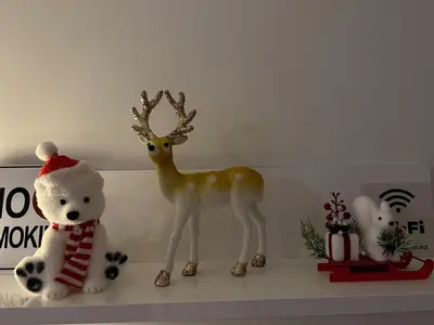 a figurine of a deer and a teddy bear on a shelf at Apartment M & N in Banja Luka
