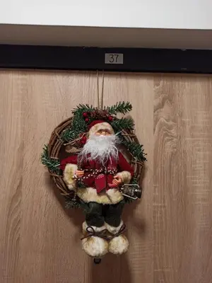 a santa claus ornament hanging on a wall at Apartment M & N in Banja Luka