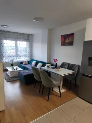 a living room with a blue couch and a table at Apartment M & N in Banja Luka